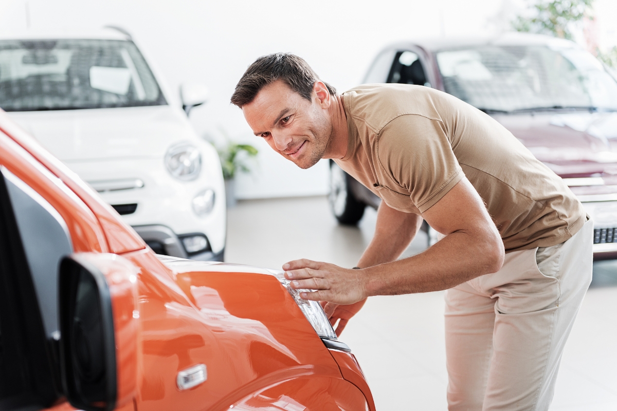 momak gleda svoj automobil